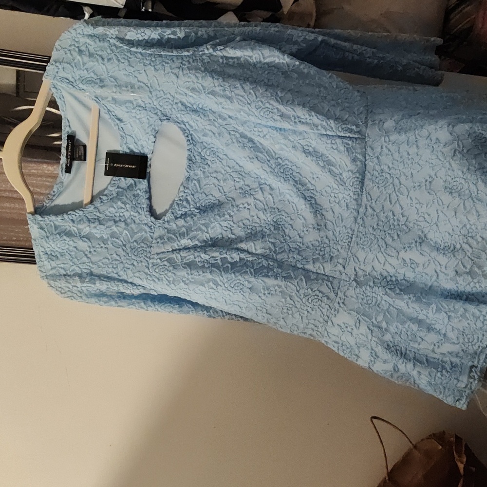 Beautiful light blue lace peplum blouse with cut out detail on chest.